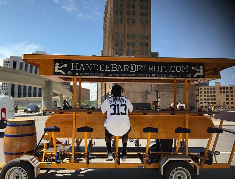 Jason Hall, Slow Roll founder, sitting on HandleBar Detroit pedal pub
