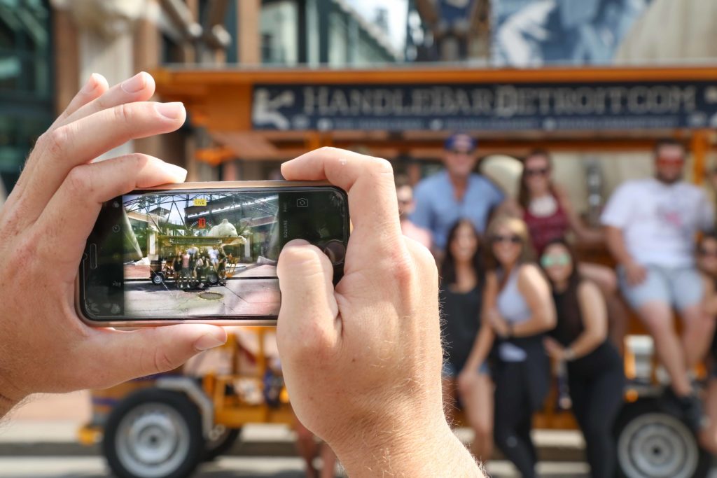 corporate tour on handlebar detroit pedal pub taking group photo